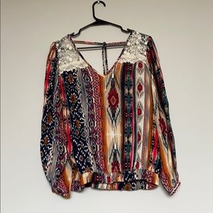 Buckles Gimmicks top with lace shoulders and tie